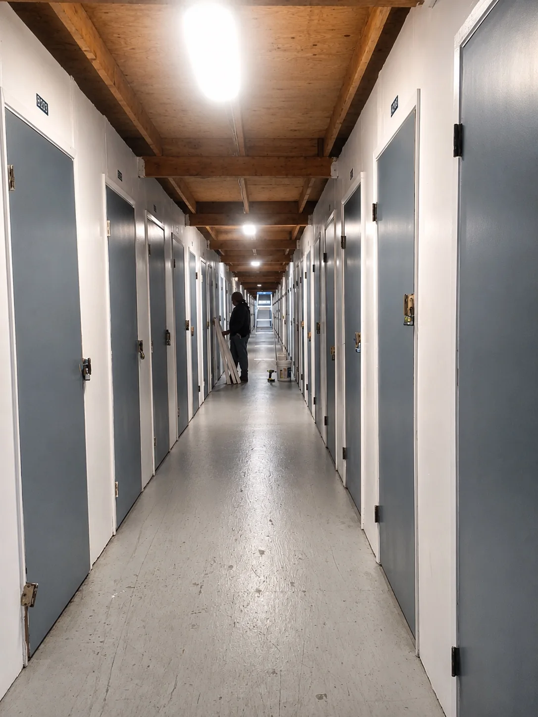 Clean, well-lit indoor hallway with storage unit doors
